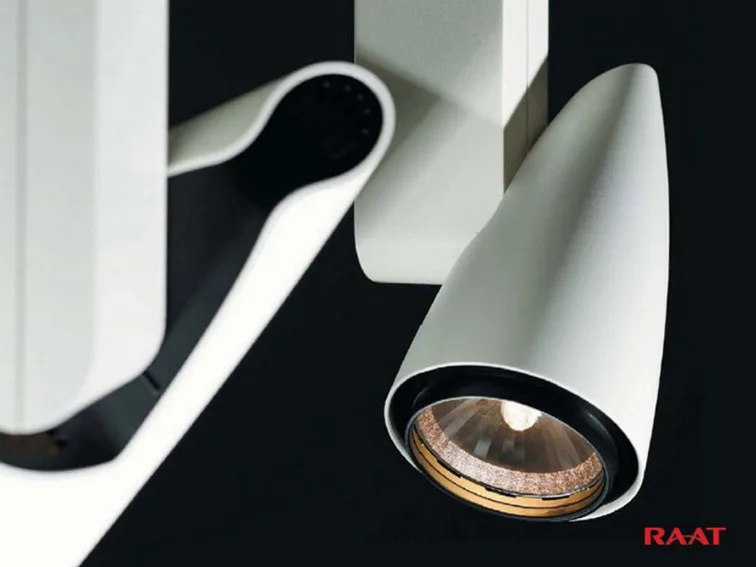 Close-up of a RAAT Kiss white conical spotlight with a warm light source and articulated arm