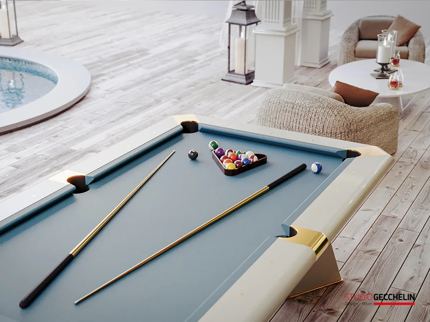Breeze billiard table with grey-blue cloth, brass pockets and cues beside a pool on a bright terrace